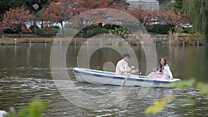 Young couples row boats in autumn Ueno park