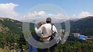 Young couples went to the tourist city of Jermuk, stand on the mountain and manually show each other what picturesque places