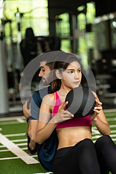 Young couples work out at the gym to strengthen the body