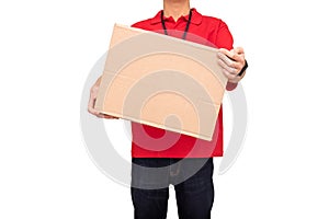 Young courier dressed in red T-shirt with name tag holding parcel isolated on white background. Delivery service concept