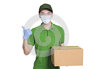 Young courier, employed wearing green clothes and hats, protective masks and gloves to protect himself, delivering packages during