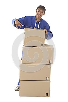 Young courier man closing a moving box