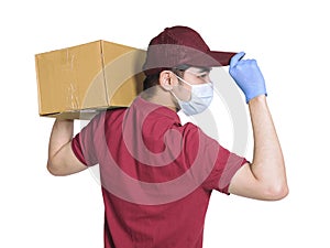 Young couriers wear medical masks  during the covid-19 epidemic. The package is carried on the shoulder, and the hand  touching th photo
