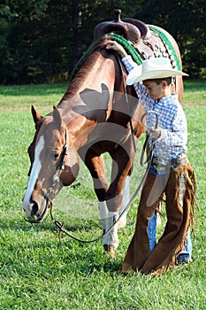 Young cowboy and horse photo