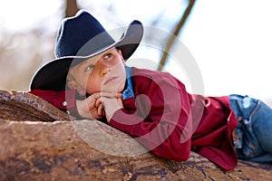 Young cowboy reclining