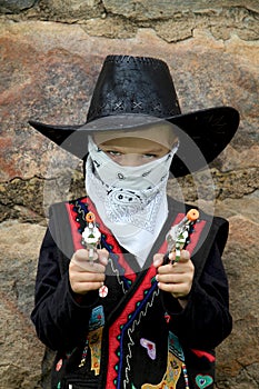 Young cowboy with toy guns