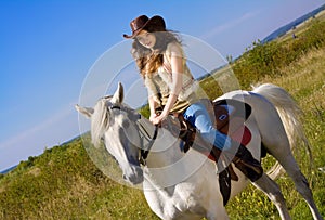 Young cowgirl on horse