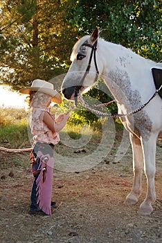 Young cowgirl with pony.