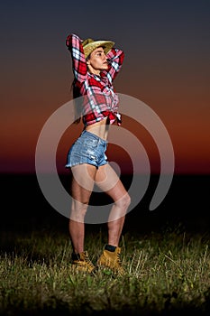 Young cowgirl at sunset