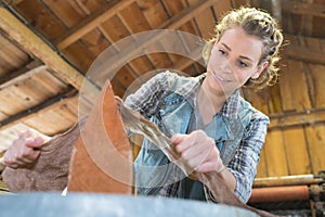 Young craftswoman produces objects in workshop