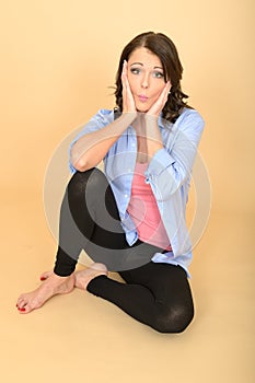 Young Crazy Woman Sitting on the Floor Pulling Silly Facial Expression