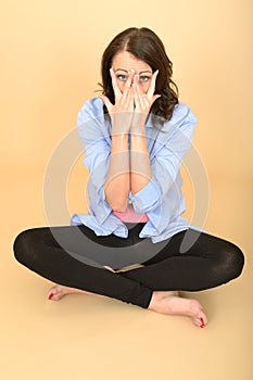 Young Crazy Woman Sitting on the Floor Pulling Silly Facial Expression