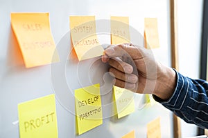 Young creative business people use post it notes sticky note on board to share idea, Analysis data chart and graph with planning
