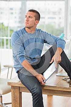 Young creative businessman holding a tablet