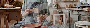 Female potter making earthenware in pottery workshop