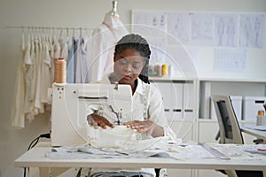 young creative female designer or stylist designers working in atelier and sewing new clothes