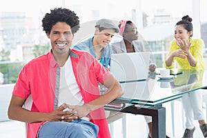 Young creative man smiling at camera