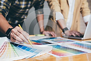 Young creative team having a meeting in creative office, Architectural drawing with work tools and accessories, Color swatch