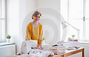 Young creative woman in a studio, startup of small tailoring business.