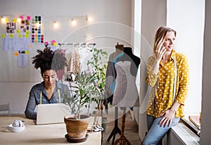 Young creative women with laptop in studio, startup business.