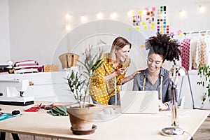 Young creative women with laptop in studio, startup business.