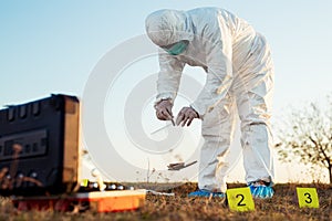 Criminologist investigates a crime scene. photo