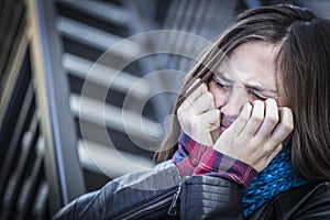 Young Crying Teen Aged Girl on Staircase