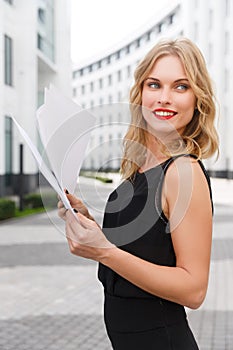 Young curly-headed blond woman with documents