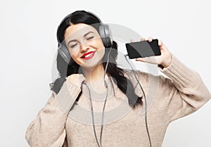 Young curvy brunette woman in headphones listening to music