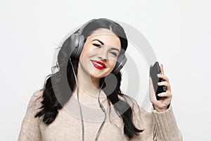 Young curvy brunette woman in headphones listening to music