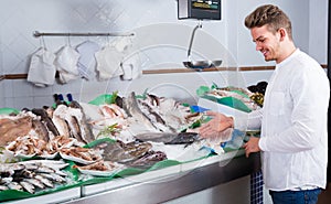 Young customer buying fish and chilled seafood