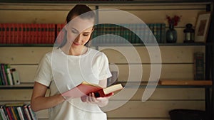 A young customer reads a book in a bookstore, tries some good literature. Portrait of a serious young student reading a