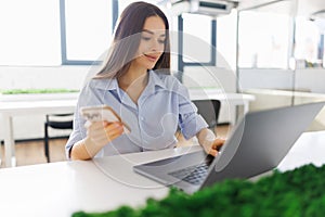Young customer service representative doing video call on laptop at office