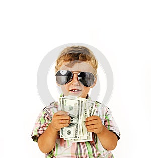 Young cute boy holding lot of cash, american dollars isolated close up