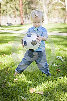 Young Cute Boy Playing with Soccer Ball in Park