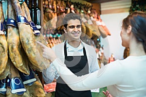 Young cute brunette choosing iberico and serrano jamon