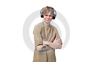 young cute caucasian guy with red hair listens to favorite playlist in headphones