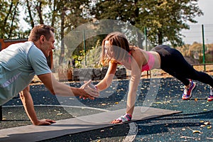 Young Cute Couple Exercising At The City Park. Outdoor Sport.