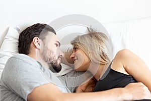 Young cute couple hug and sleep together in bed