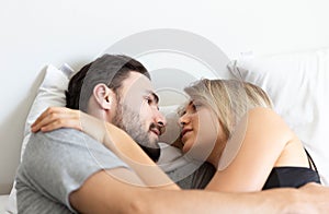 Young cute couple hug and sleep together in bed