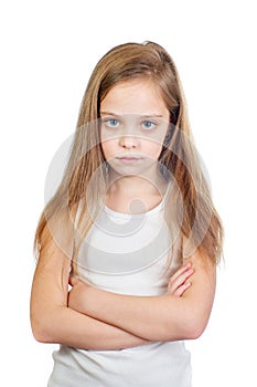 Young cute displeased girl with grey blue eyes, long light brown hair and crossed arms