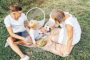 Young cute family on picnic with dog