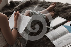 Young Cute Female Student Doing Homework in Bed