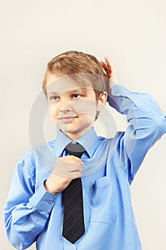 Young cute gentleman straighten tie over bright shirt