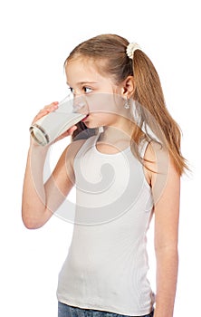 Young cute girl with grey blue eyes and two hair tails drinks milk