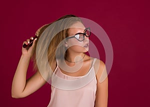 Young cute girl with hairbrush, isolated