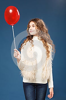 Young cute girl with heart-shaped ballon