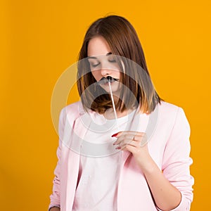 Young cute girl with moustache, studio