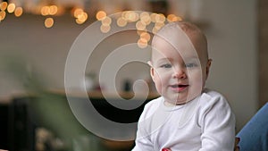 Young cute girl playing with her son on the bed. A young mother is playing with a baby on the bed.