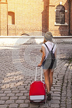 Young cute girl travels through the cities of old Europe.